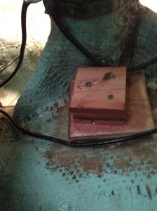 Rudder position sensor mount fabricated from plywood and epoxy.